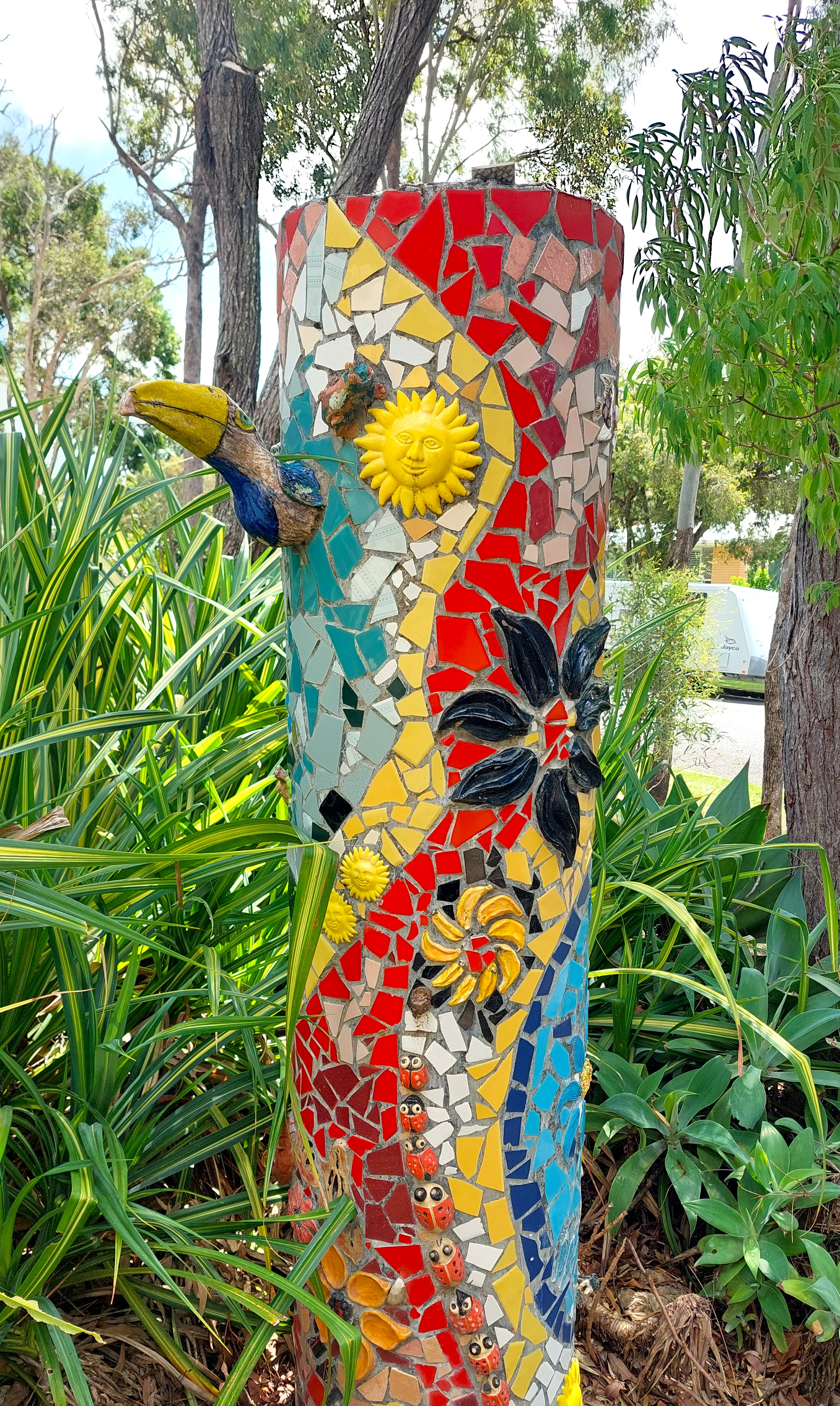 Vibrant mosaic totem pole created by Bay Potters members